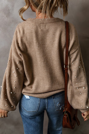 Back view of beige pearl detail long sleeve sweater