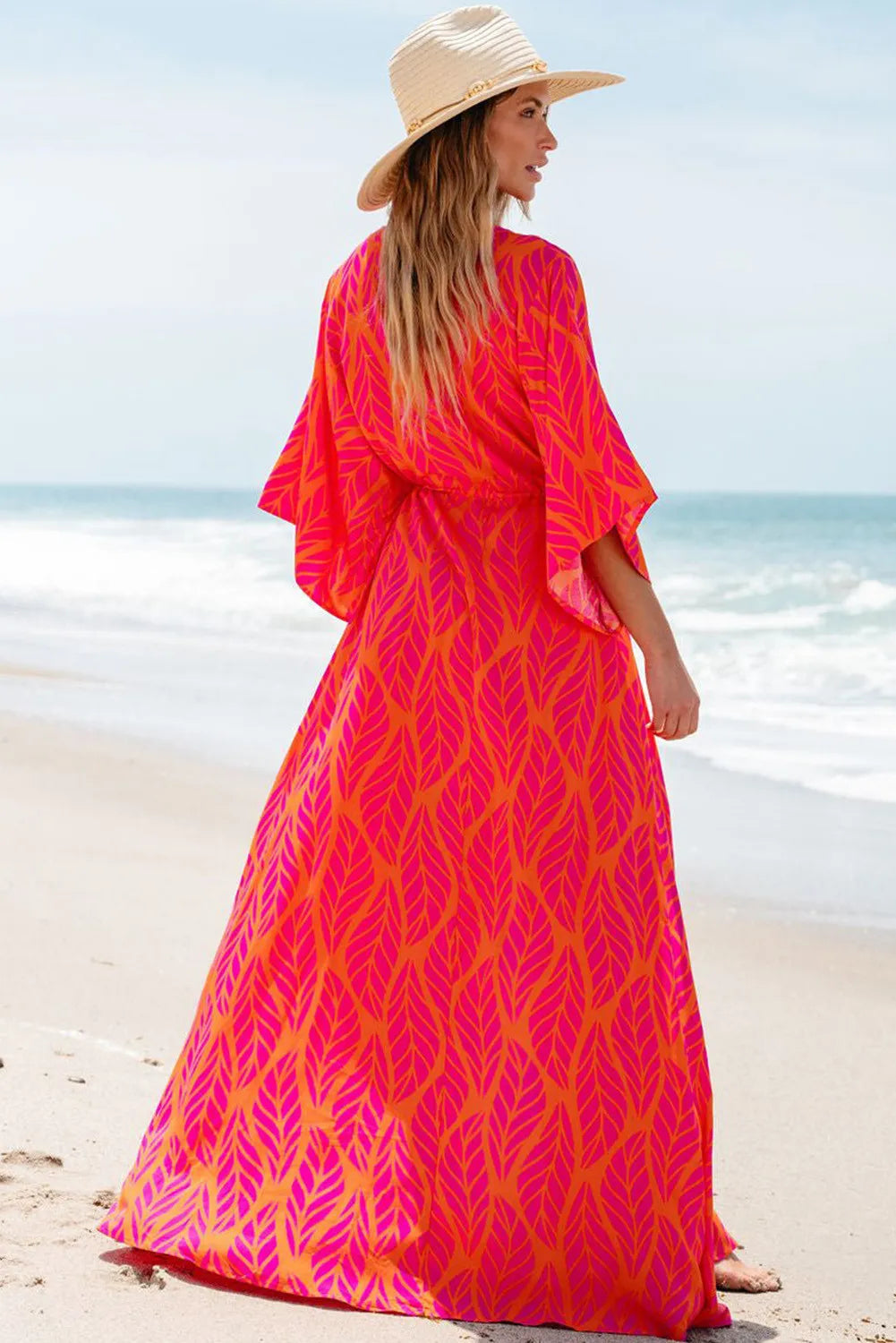 Back view of colorful printed V-neck maxi dress on beach