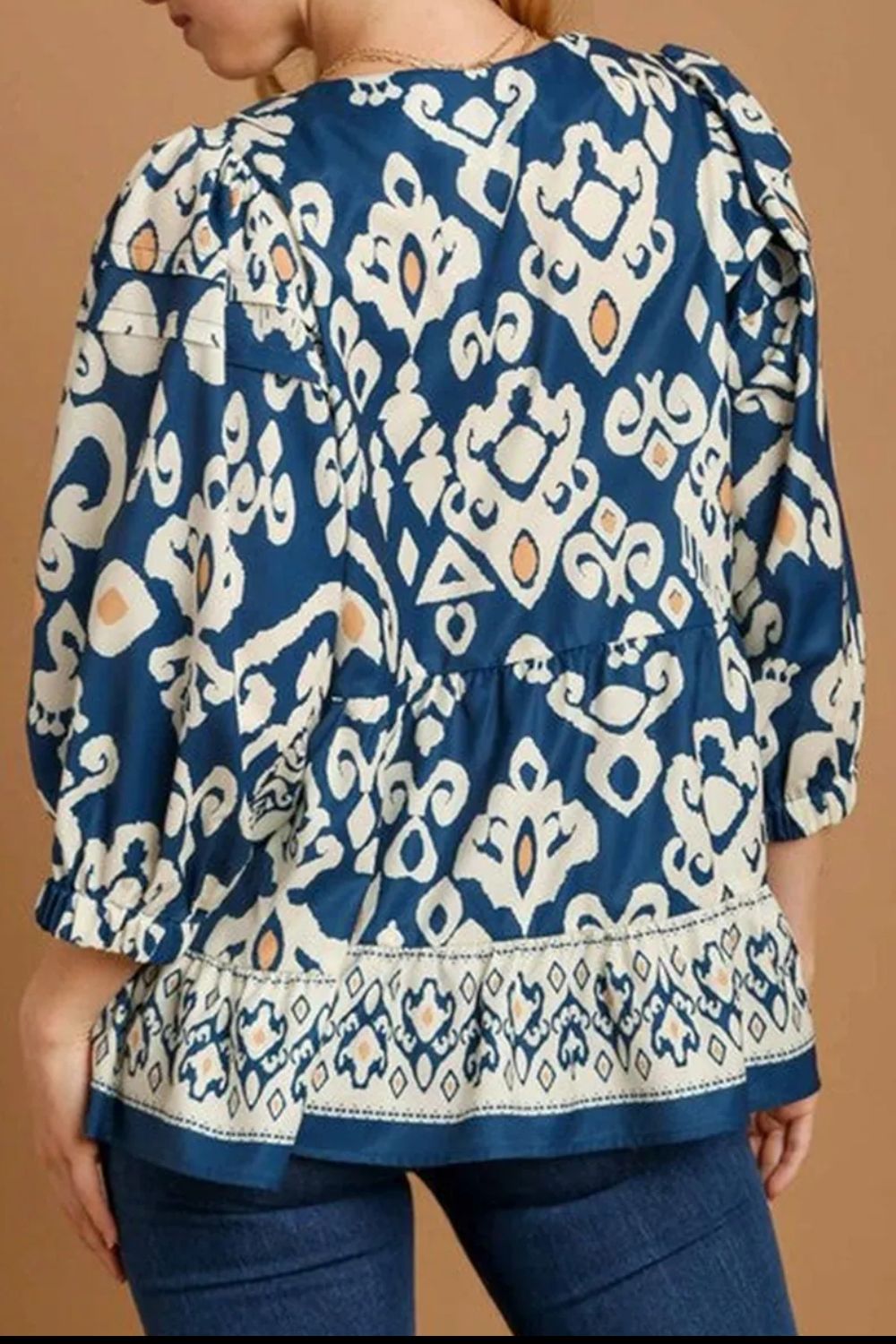 Back view of printed V-neck three-quarter sleeve blouse