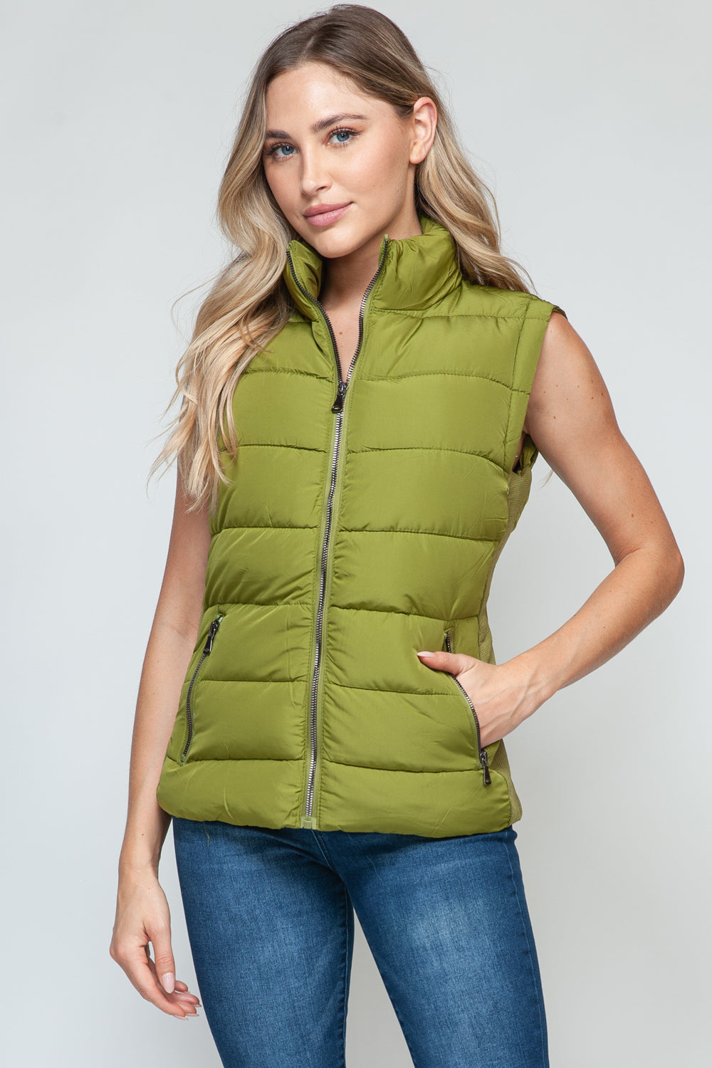 Zip up turtleneck vest with pockets in cardamom seed.