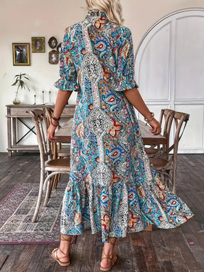 Back view of blue printed tie neck flounce sleeve midi dress