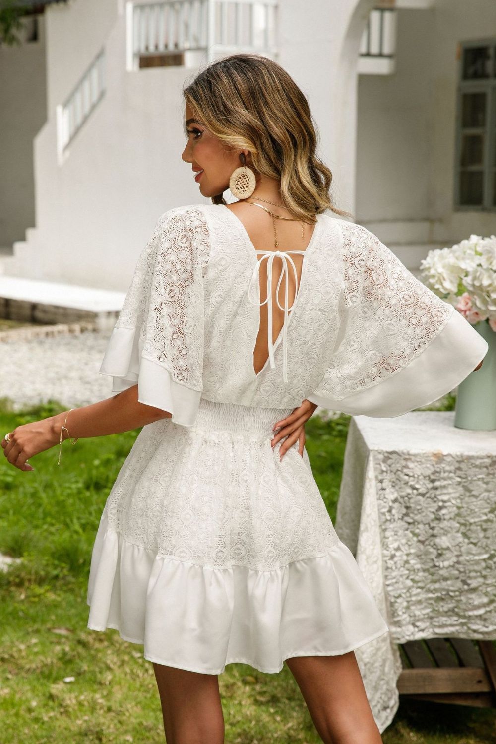 Lace cutout surplice dress with tie-back detail outdoors