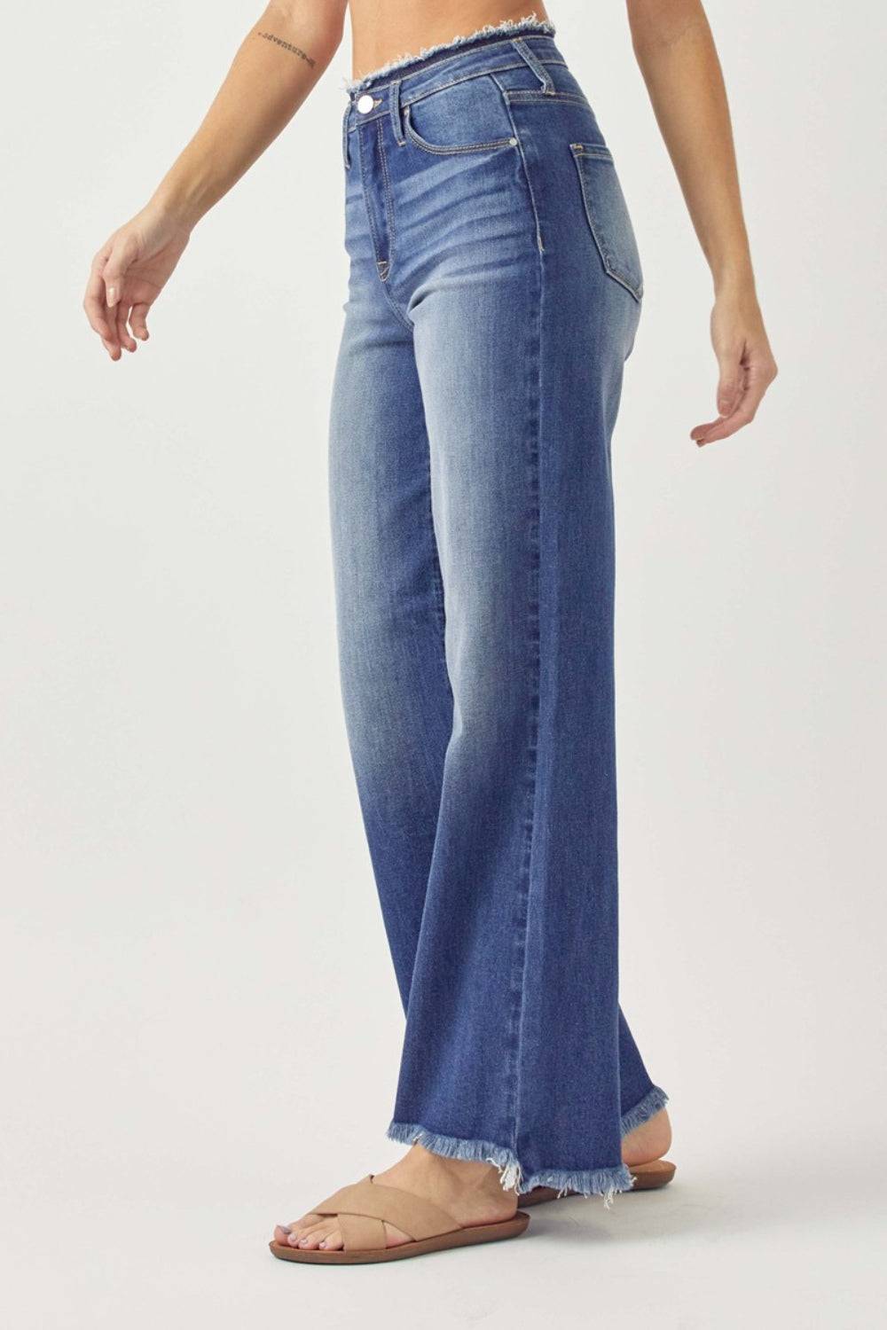 a woman is wearing a pair of high rise jeans