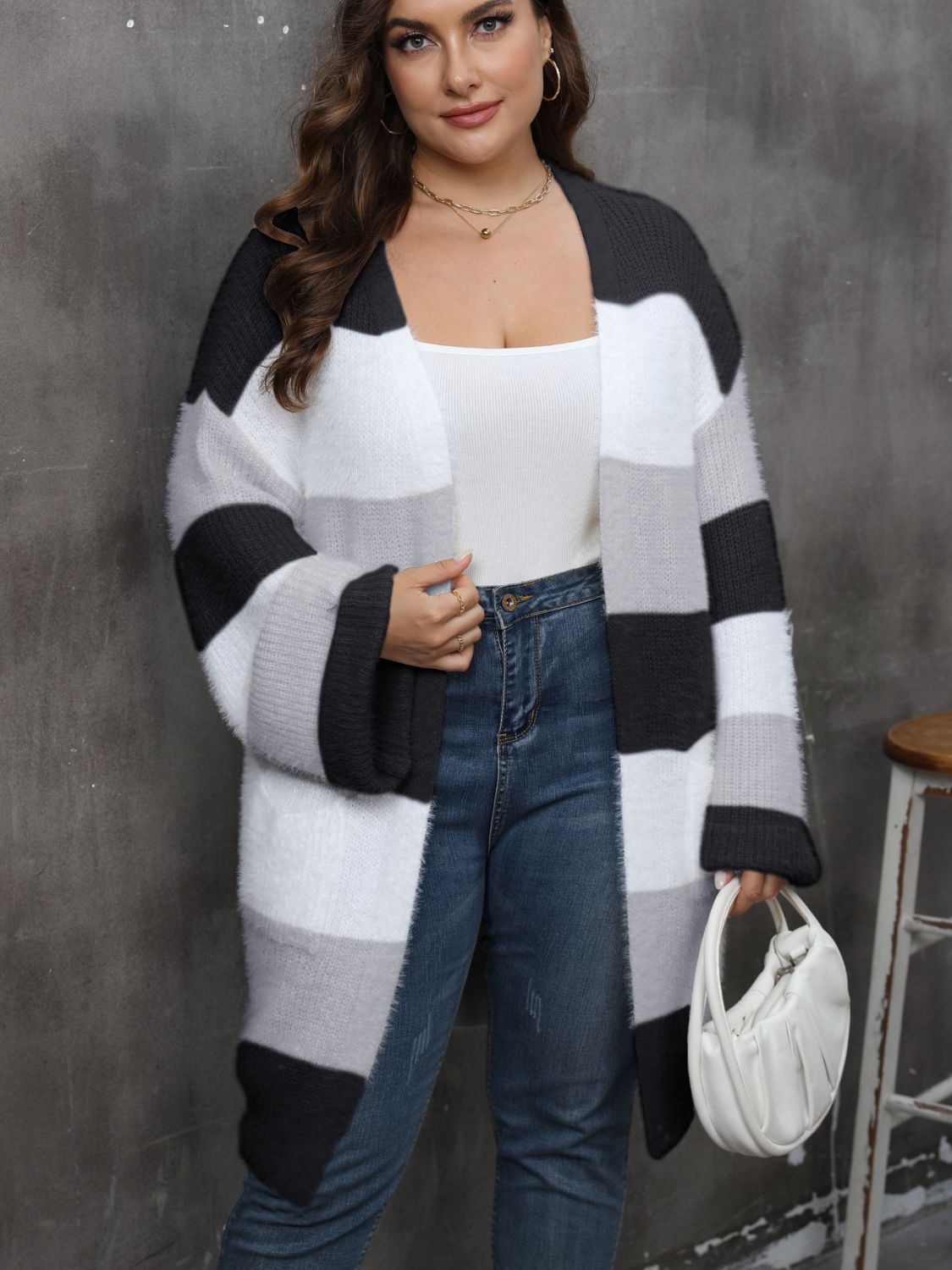 a woman wearing a black and white striped cardigan