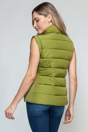 Back view of zip up turtleneck vest in cardamom seed.