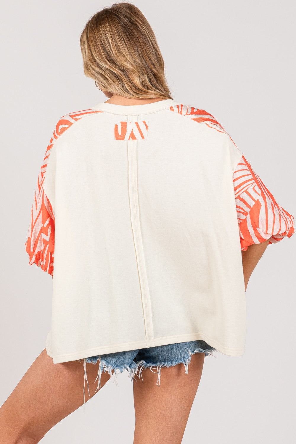 Back view of SAGE + FIG top with zebra print contrast sleeves