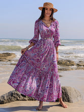 Printed tie neck balloon sleeve maxi dress on beach