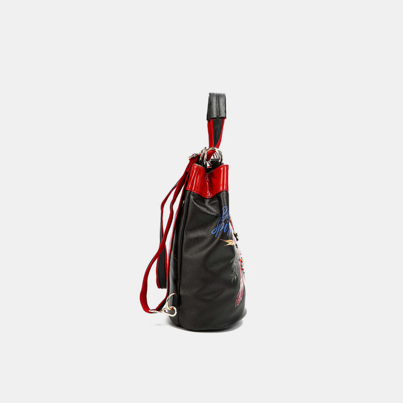 Side view of Nicole Lee USA bucket bag with red accents