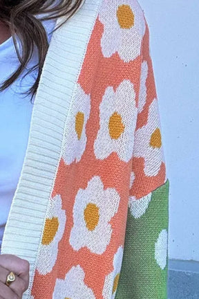 Close-up of floral design on color block cardigan