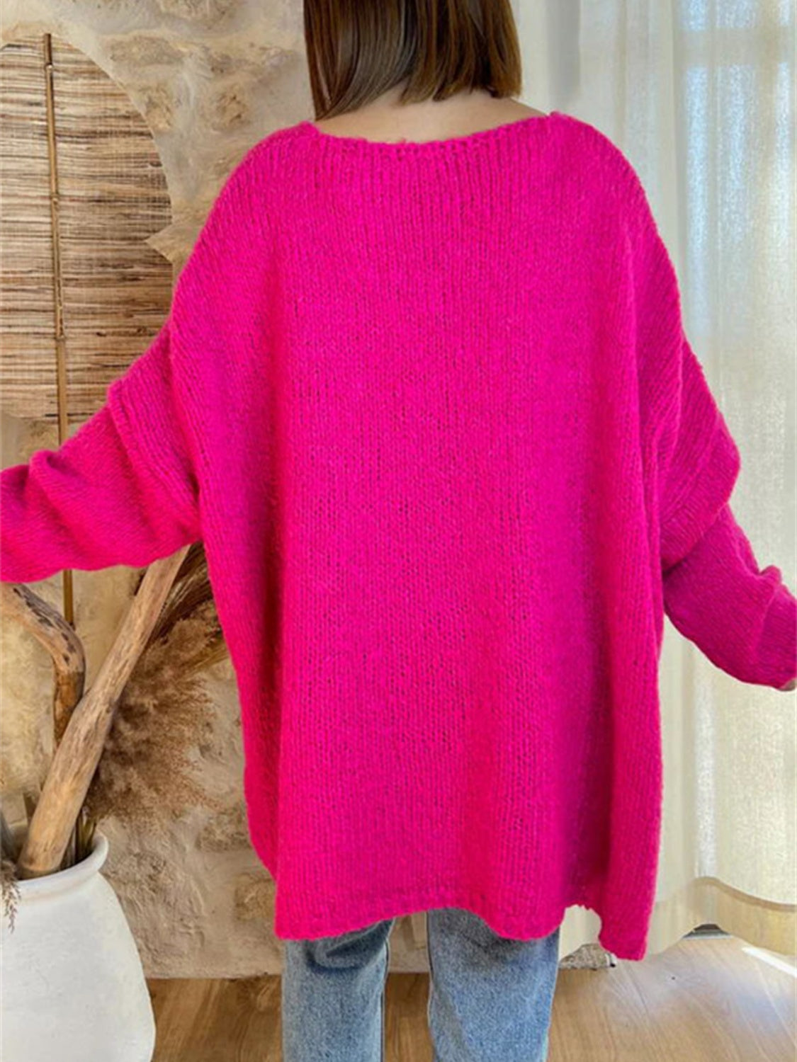 Back view of pink V-neck sweater