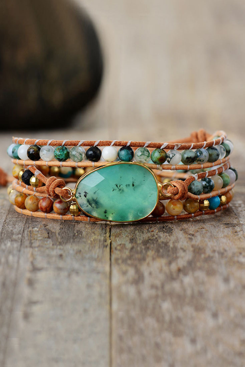 Natural stone and agate layered bracelet on wood surface