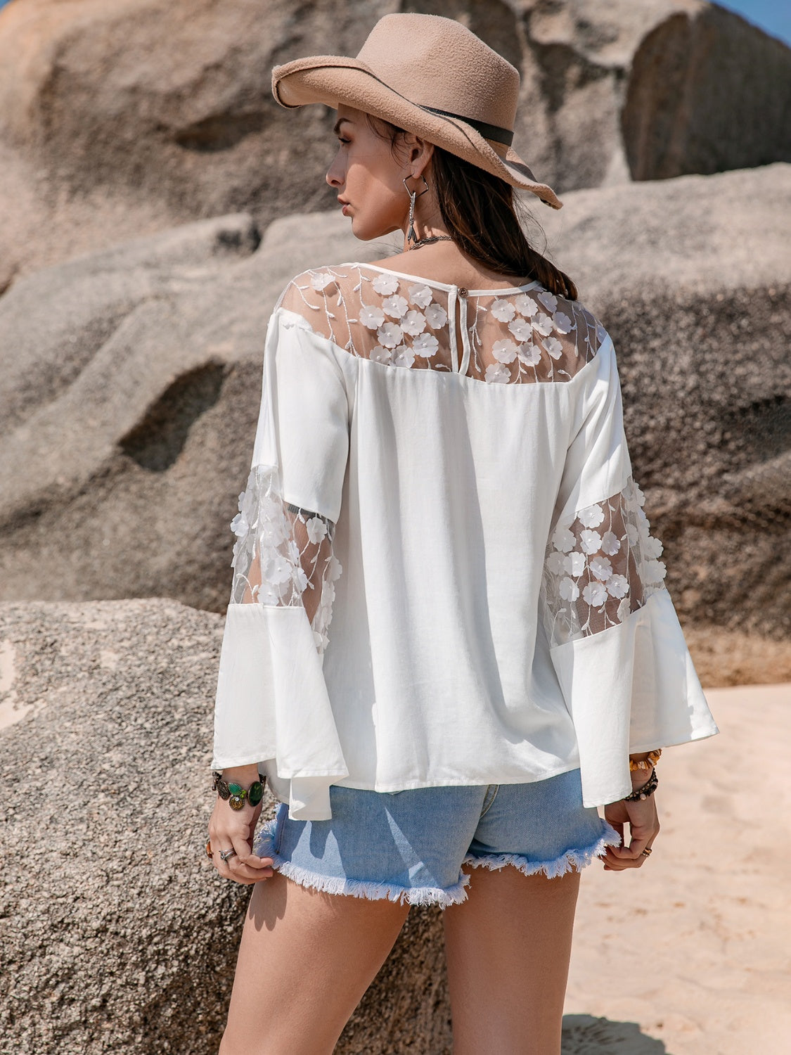 Woman in lace round neck long sleeve blouse, back view