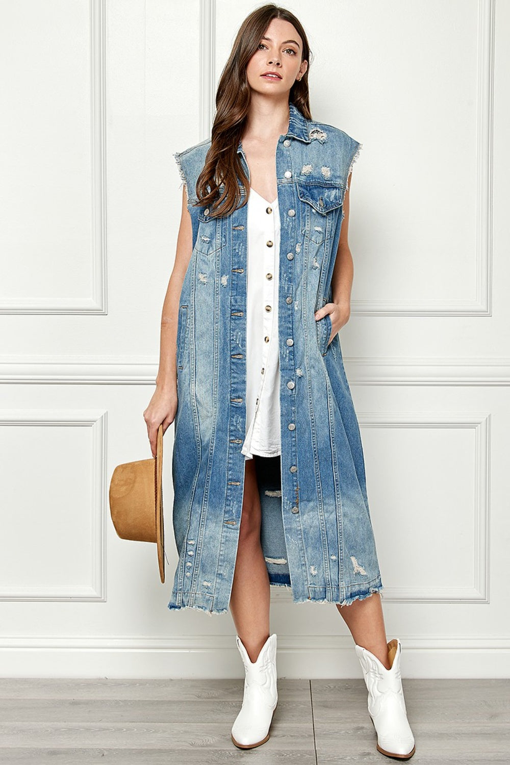 Front view of distressed sleeveless longline denim jacket