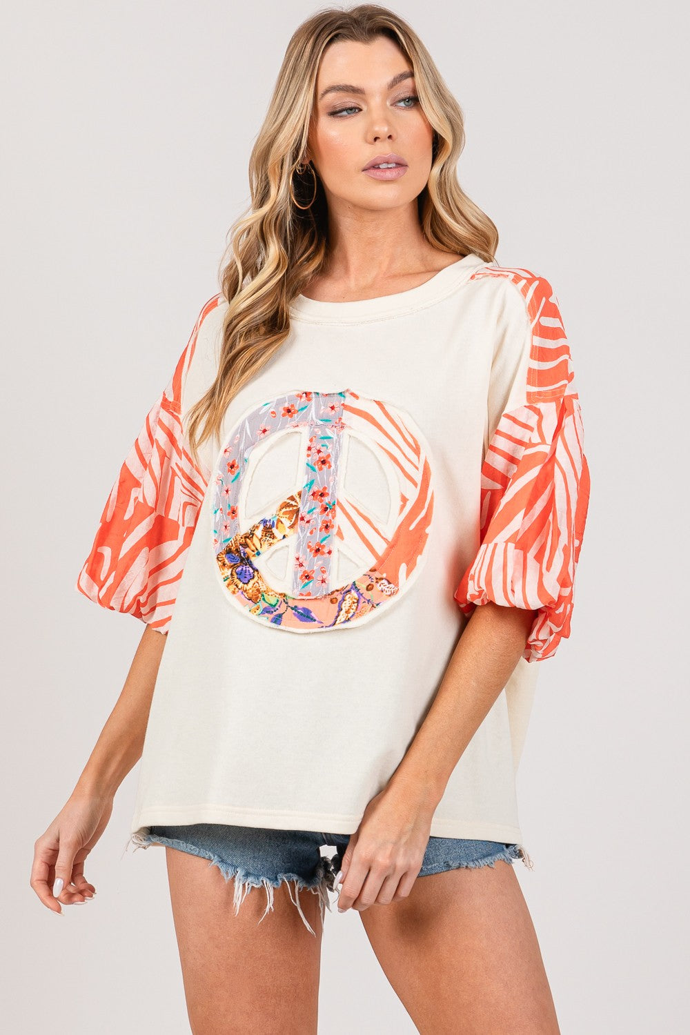 SAGE + FIG top with peace applique and zebra print sleeves