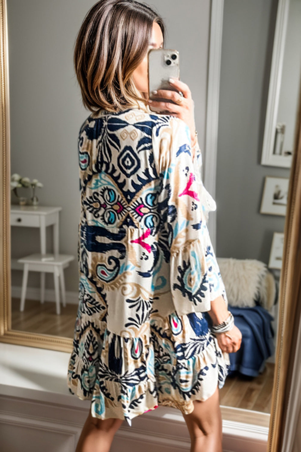 Back view of printed button up mini dress with colorful design