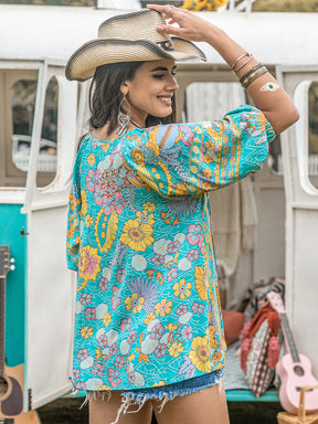 Back view of printed tie neck half sleeve blouse with floral design