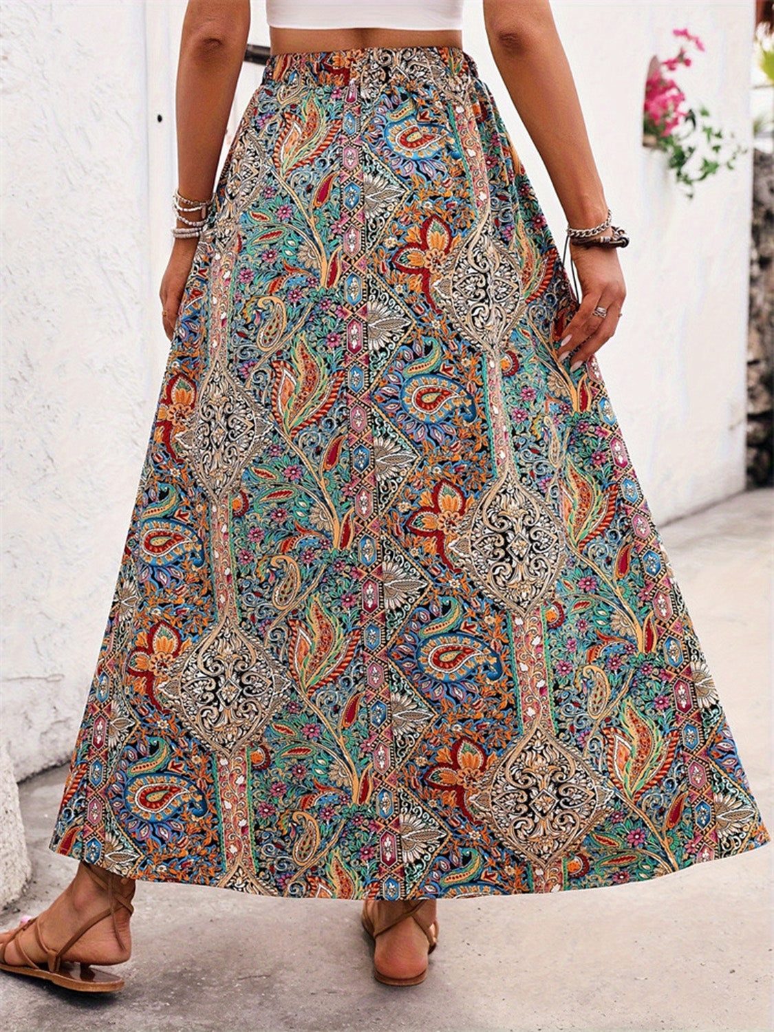 Back view of paisley slit skirt, elastic waist, vibrant print