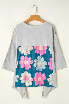 Light green floral blouse on hanger with three-quarter sleeves