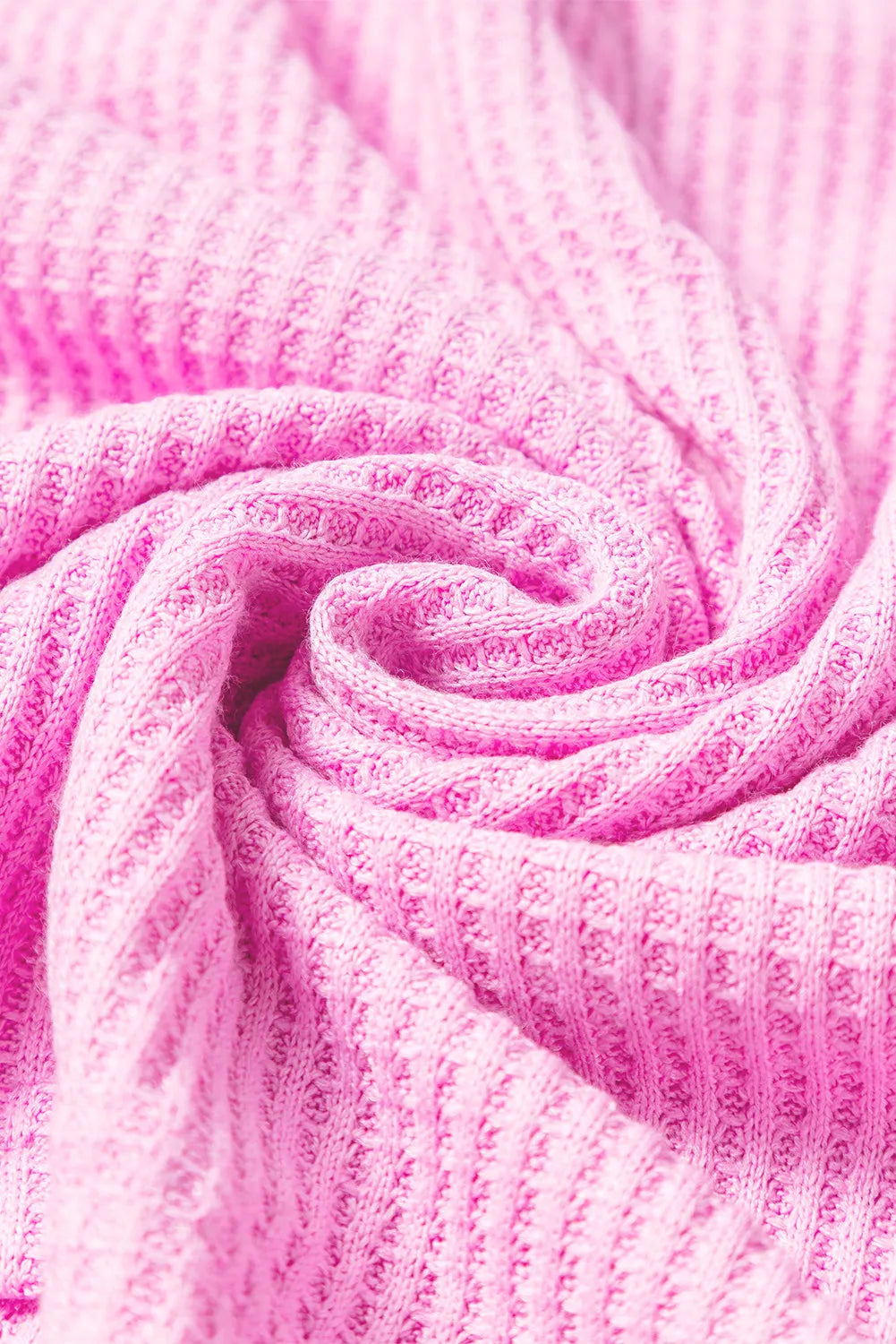 Close-up of pink waffle-knit fabric texture