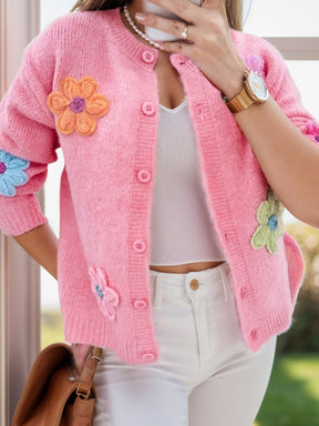 Pink cardigan with floral design and dropped shoulders