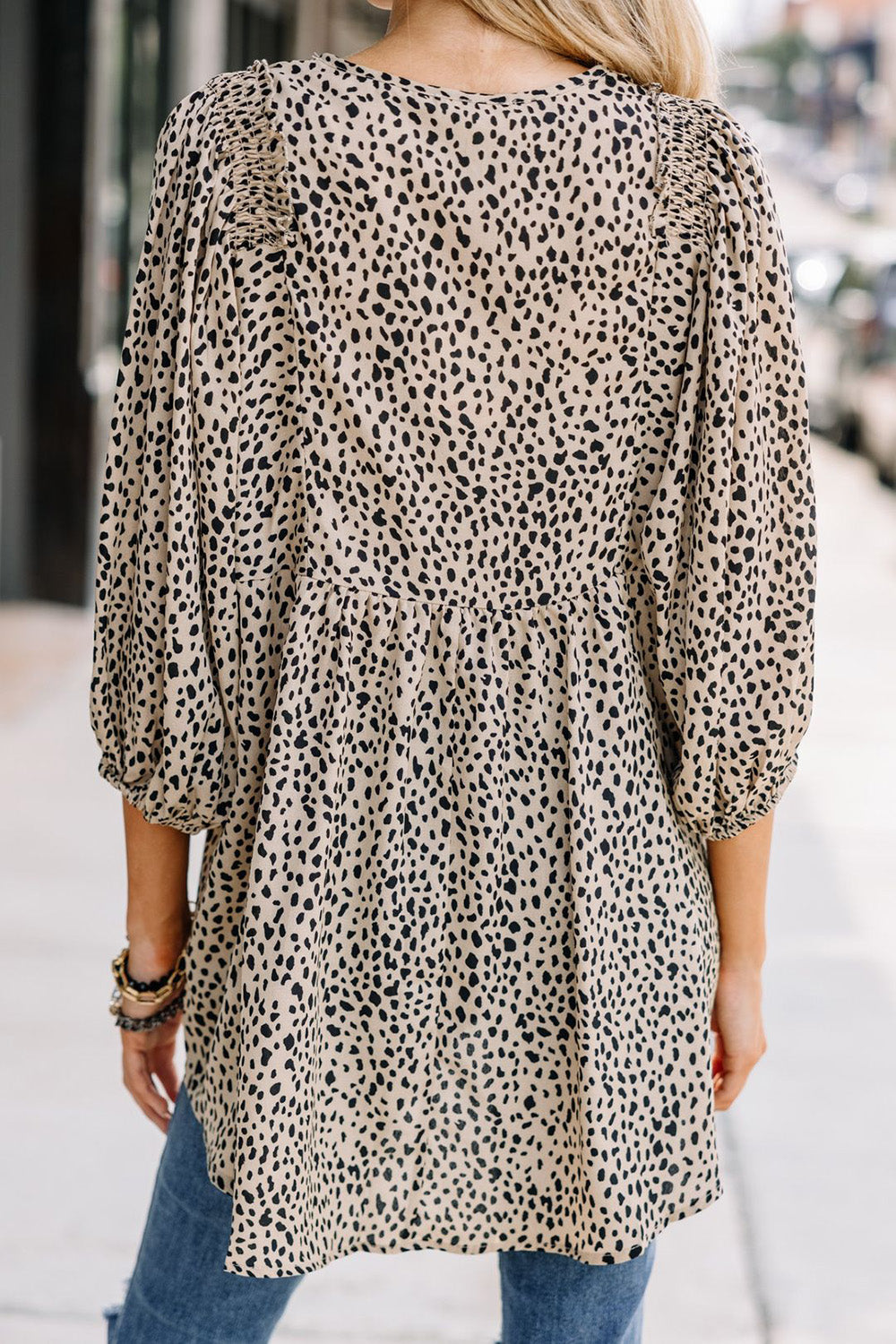 Back view of animal print V-neck blouse with three-quarter sleeves.