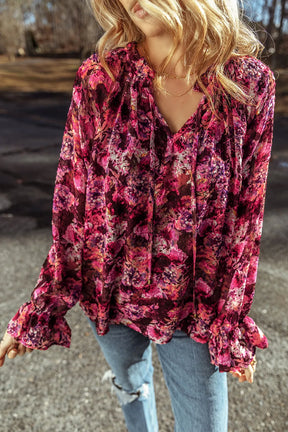 Printed tie neck flounce sleeve blouse in vibrant floral pattern