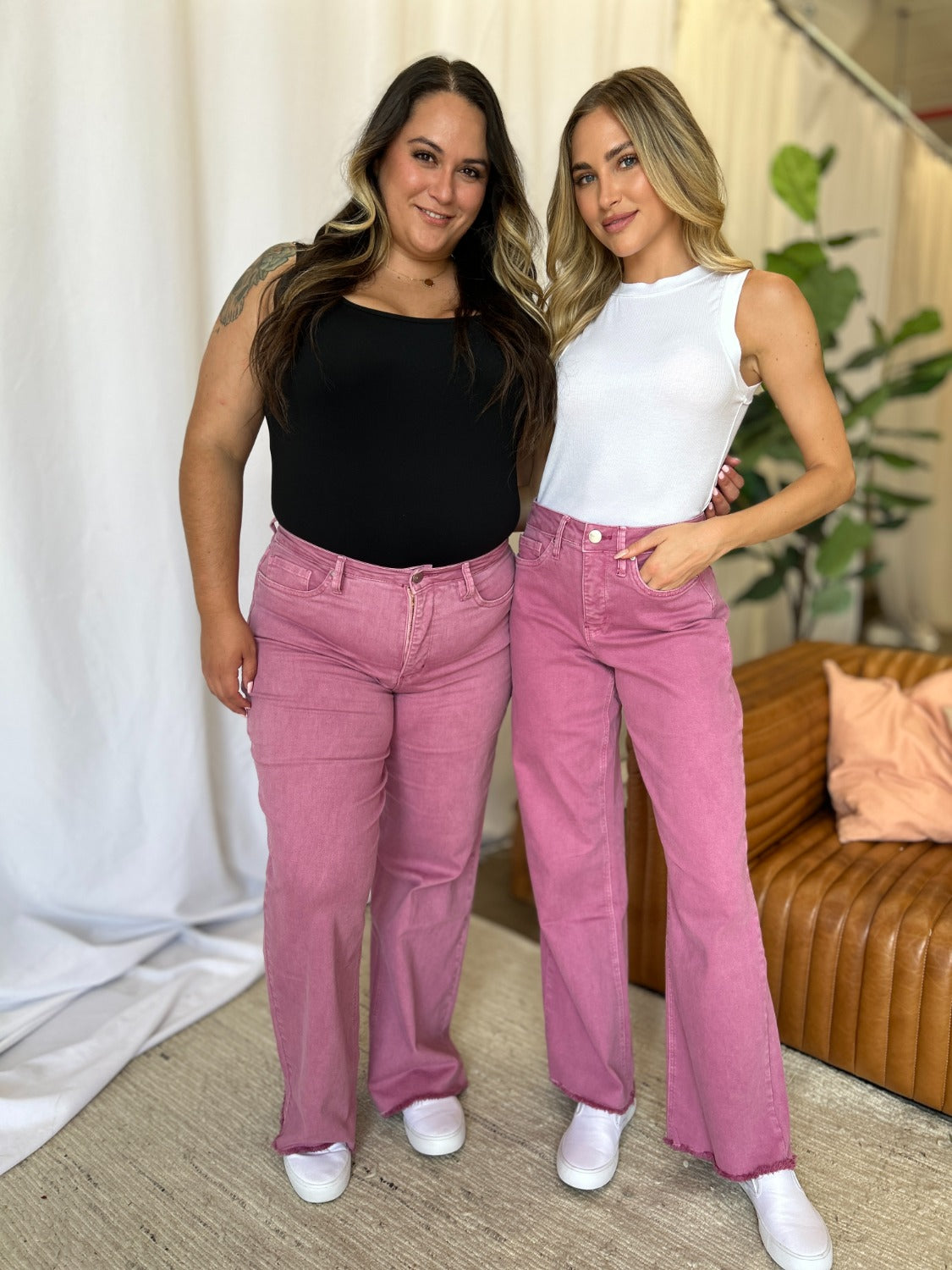 Two women wearing RFM high rise wide leg jeans in French Rose.